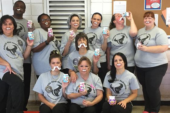 Photo of volunteers wearing fake milk mustaches and holding milk cartons