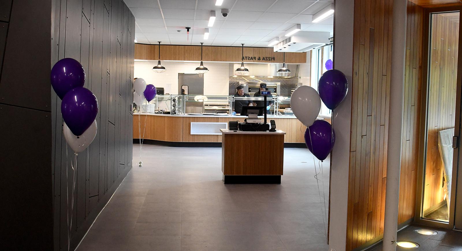Photo of the entryway to the newly remodeled Anderson Dining Hall, with purple balloons